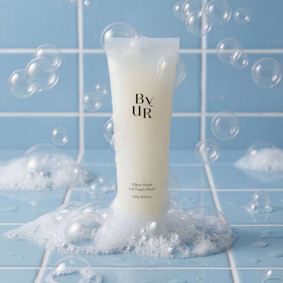 Tube of ByUR Gel Foam Wash with bubbles on a tile counter